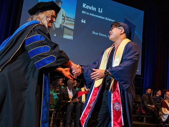 Dean and graduating student