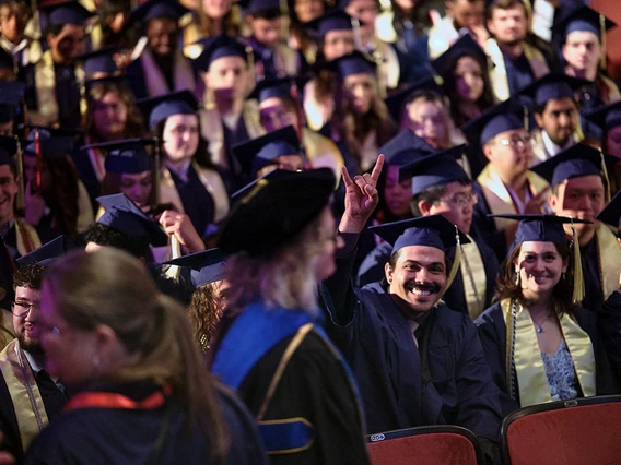 Graduating students, with dean in foreground