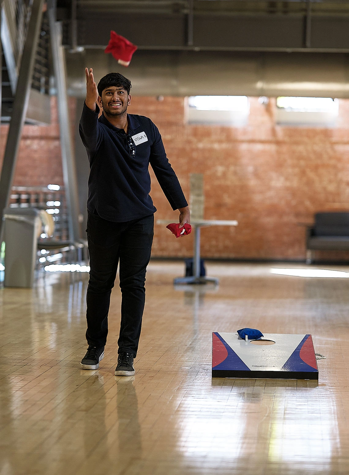 Student playing cornhole
