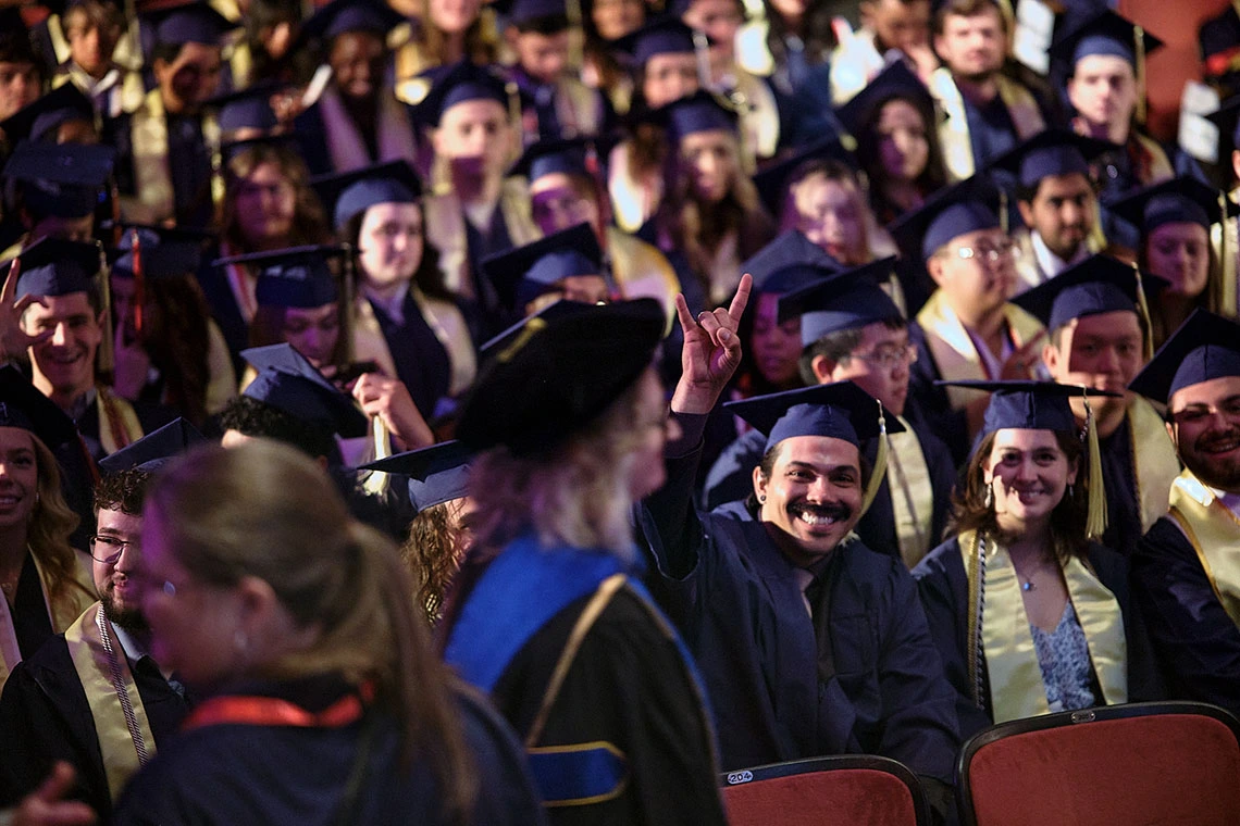 Graduating students, with dean in foreground