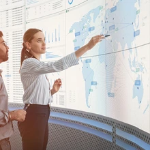 Professionals looking at digital wall with data