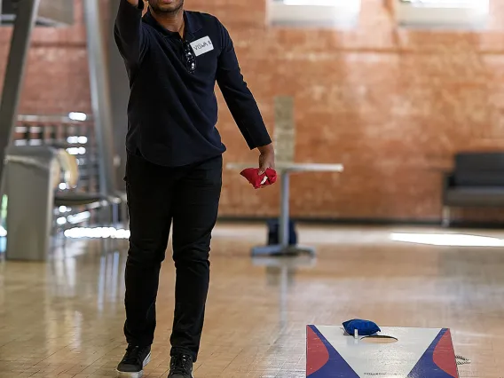 Student playing cornhole