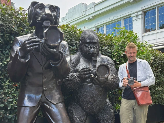 Michael McKisson with photographer statues in London