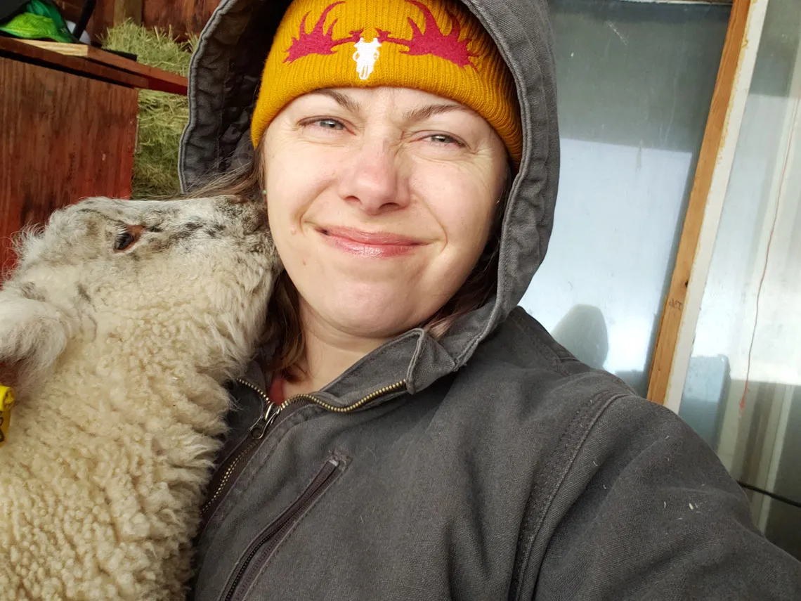 Meaghan Wetherell enjoys a kiss from one of her sheep