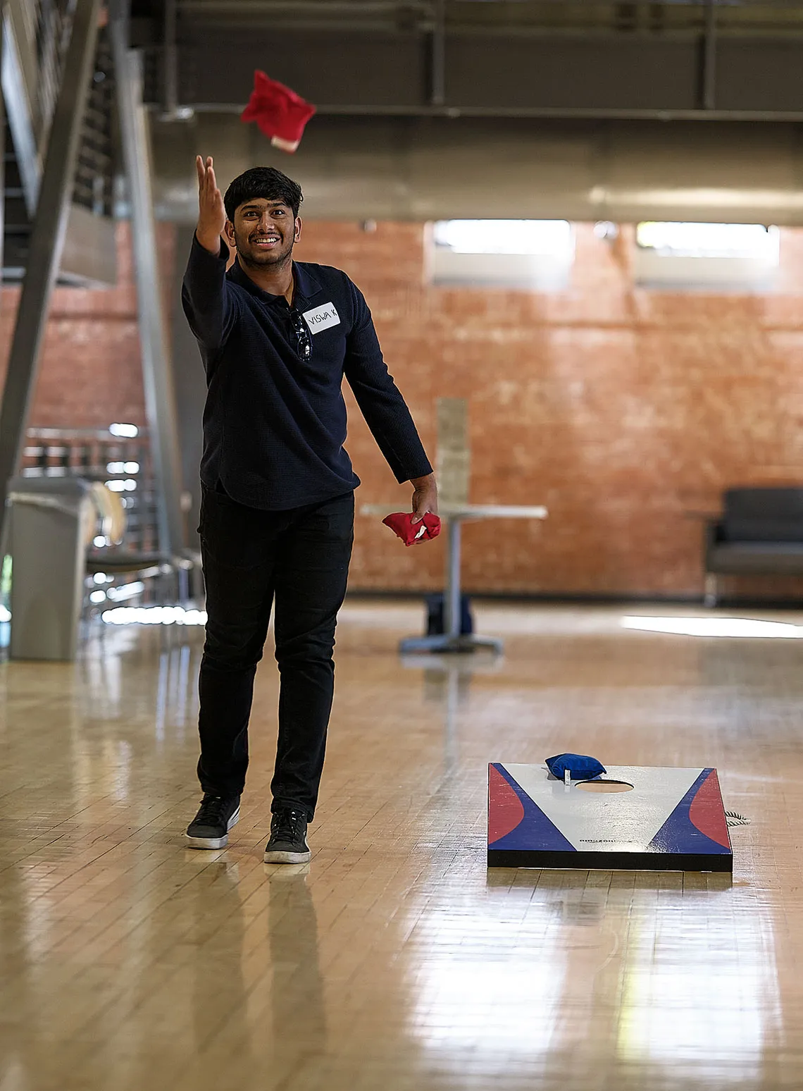 Student playing cornhole