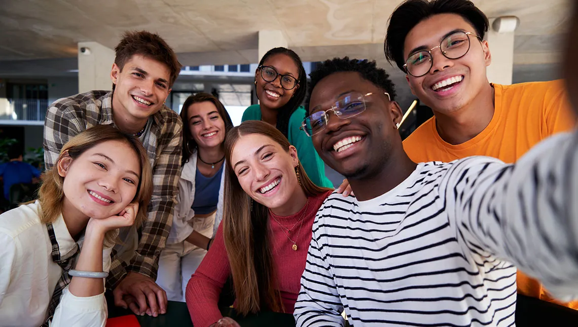 Diverse, smiling graduate students taking a selfie