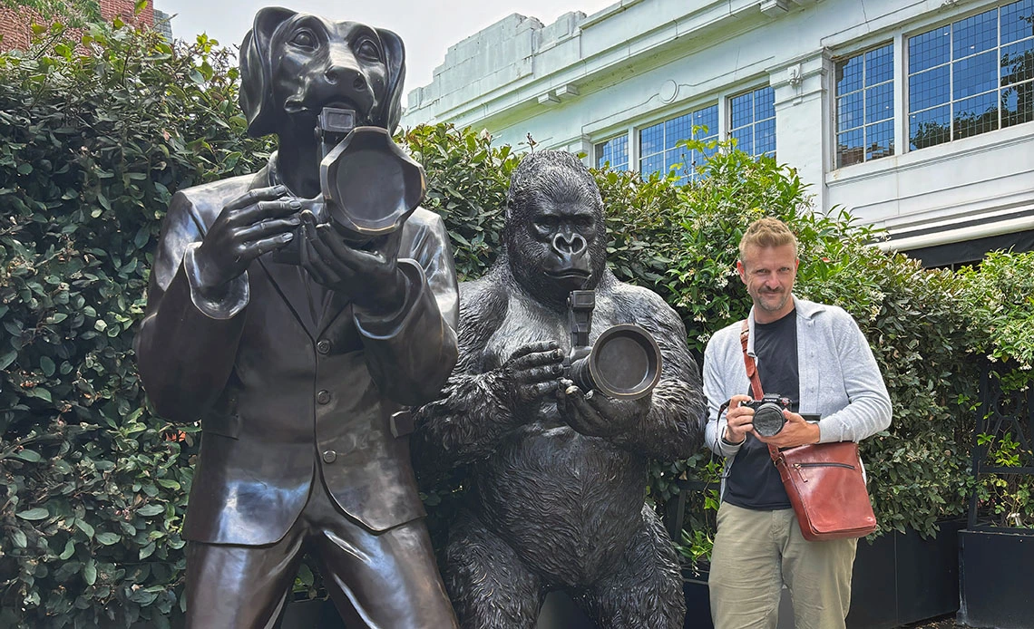 Michael McKisson with photographer statues in London